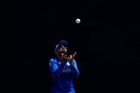 Rashid Khan prepares to take the catch to dismiss Rohit